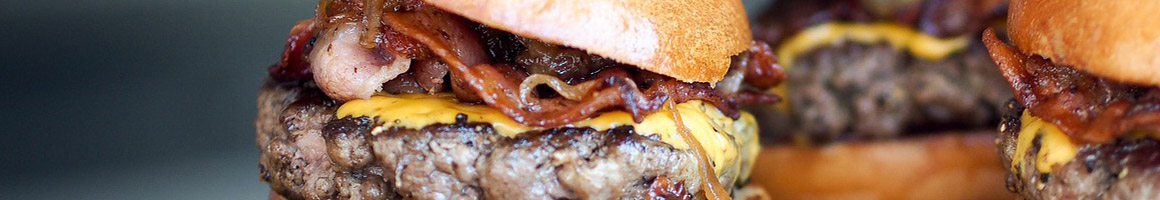 Eating Burger at Bravo’s Char Burger restaurant in Inglewood, CA.